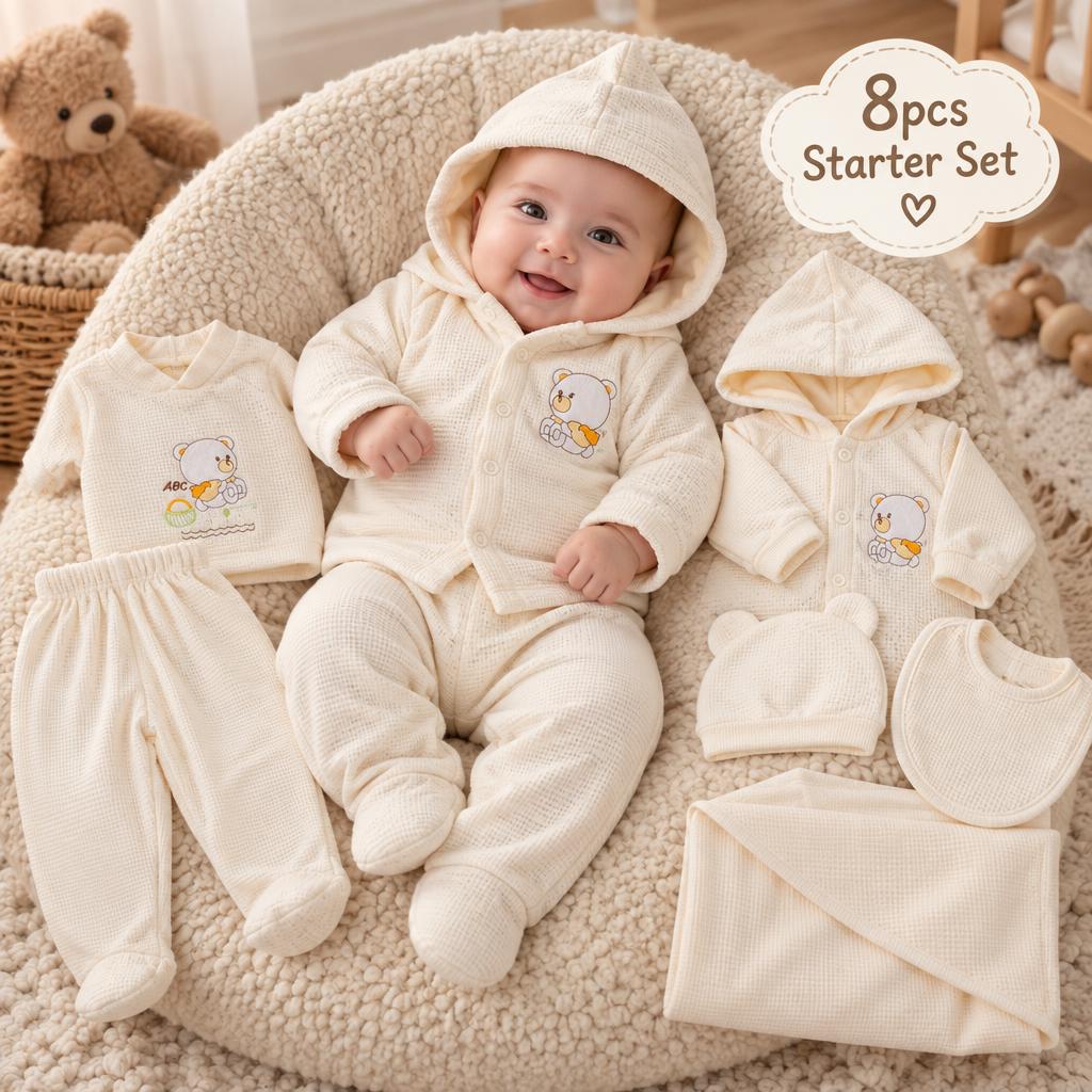 Cream newborn bear waffle starter set displayed with baby wearing the hooded cardigan and footed trouser beside the matching eight pieces.
