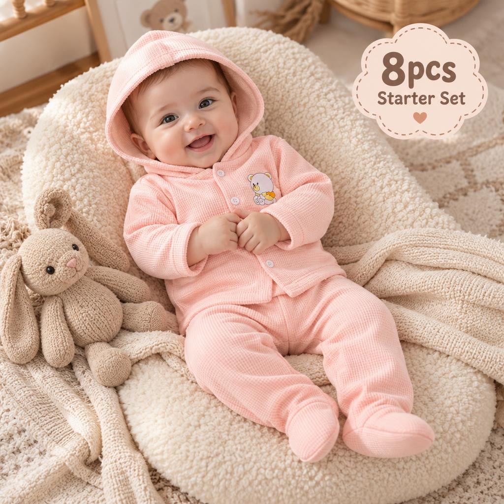 Pink newborn 8-piece bear waffle starter set shown on a baby wearing the hooded button-front cardigan and enclosed-foot trouser.