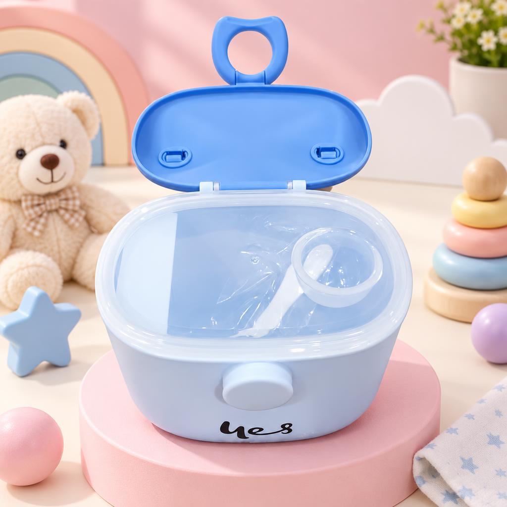 Open blue milk powder container with raised handled lid, transparent inner cover and white scoop shown inside.