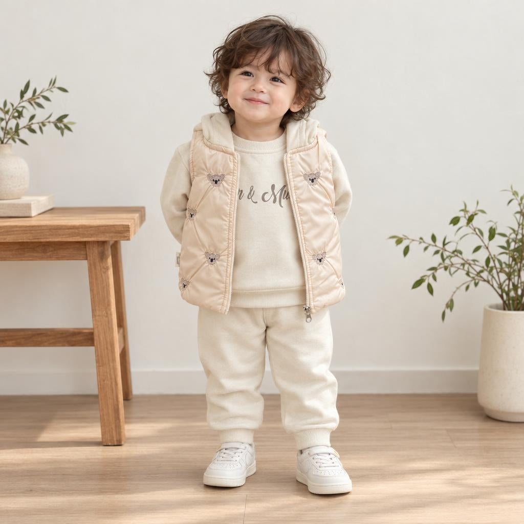 Toddler wearing the Skin hooded sweatshirt and jogger suit with a light padded zip-front waistcoat featuring small bear appliques.