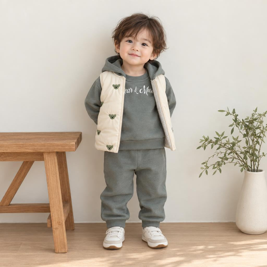 Toddler wearing the Olive Green hooded sweatshirt and jogger trousers with a light bear-applique padded waistcoat.