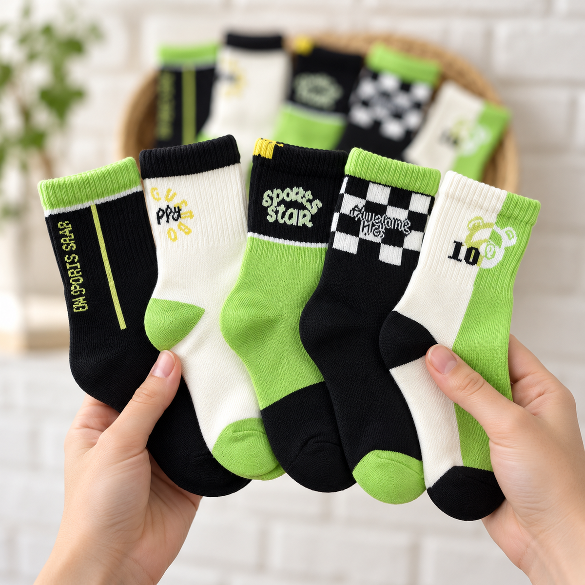 Fanned display of five kids warm sports socks in Black, White and Lime Green, showing ribbed cuffs, checkerboard print, number 10 graphic and sports lettering.