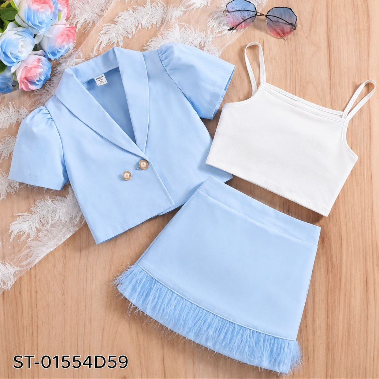 Light blue blazer, white top, and light blue skirt on a wooden surface with flowers and sunglasses.