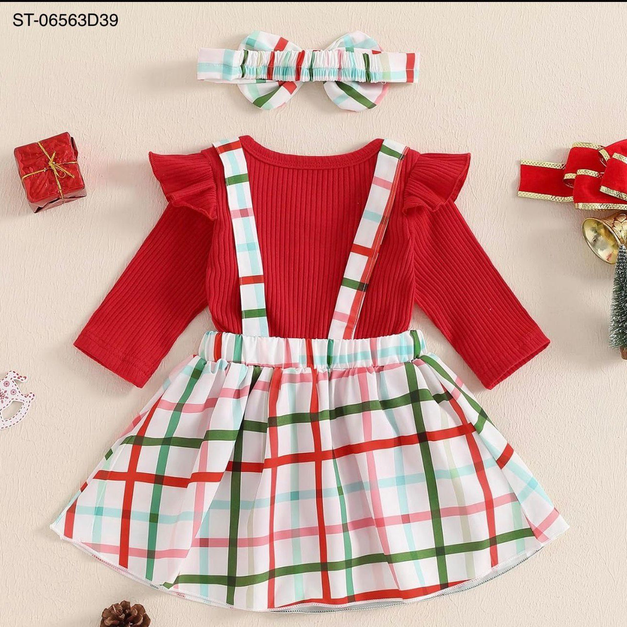 Red top with plaid suspenders and matching headband on a beige background